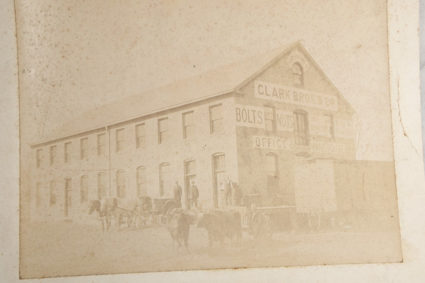 Lot 124 - Antique Boarded Occupational Photograph Of The Clarke Bros & Co. Bolts And Nuts Office And Warehouse Building With Train Car, Cattle, Horses, And Workers In Frame