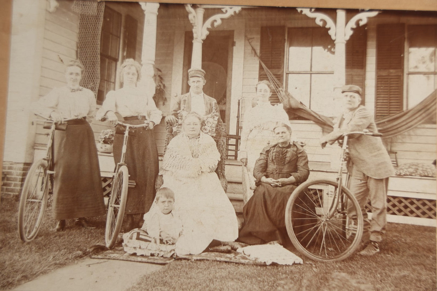 Lot 126 - Antique Boarded Photograph Of Men And Women Posing With Bicycles In Front Of Porch With Hammock, Identified On Verso