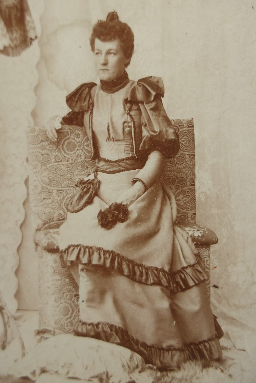 Lot 130 - Antique Boarded Photograph Of A Well Dressed Woman Posing On An Elaborate Set With Piano Lamp