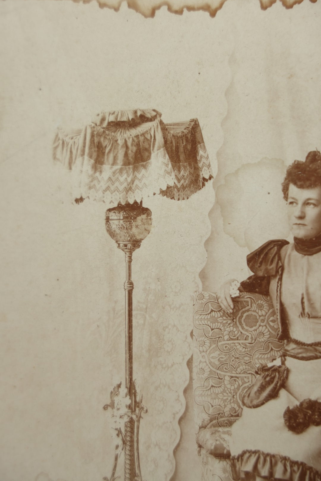 Lot 130 - Antique Boarded Photograph Of A Well Dressed Woman Posing On An Elaborate Set With Piano Lamp