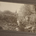 Lot 131 - Pair Of Antique Boarded Photographs Of Outdoor Scenes, Including Boy And Girl On Primitive Stick Bridge Crossing Creek, Canoe