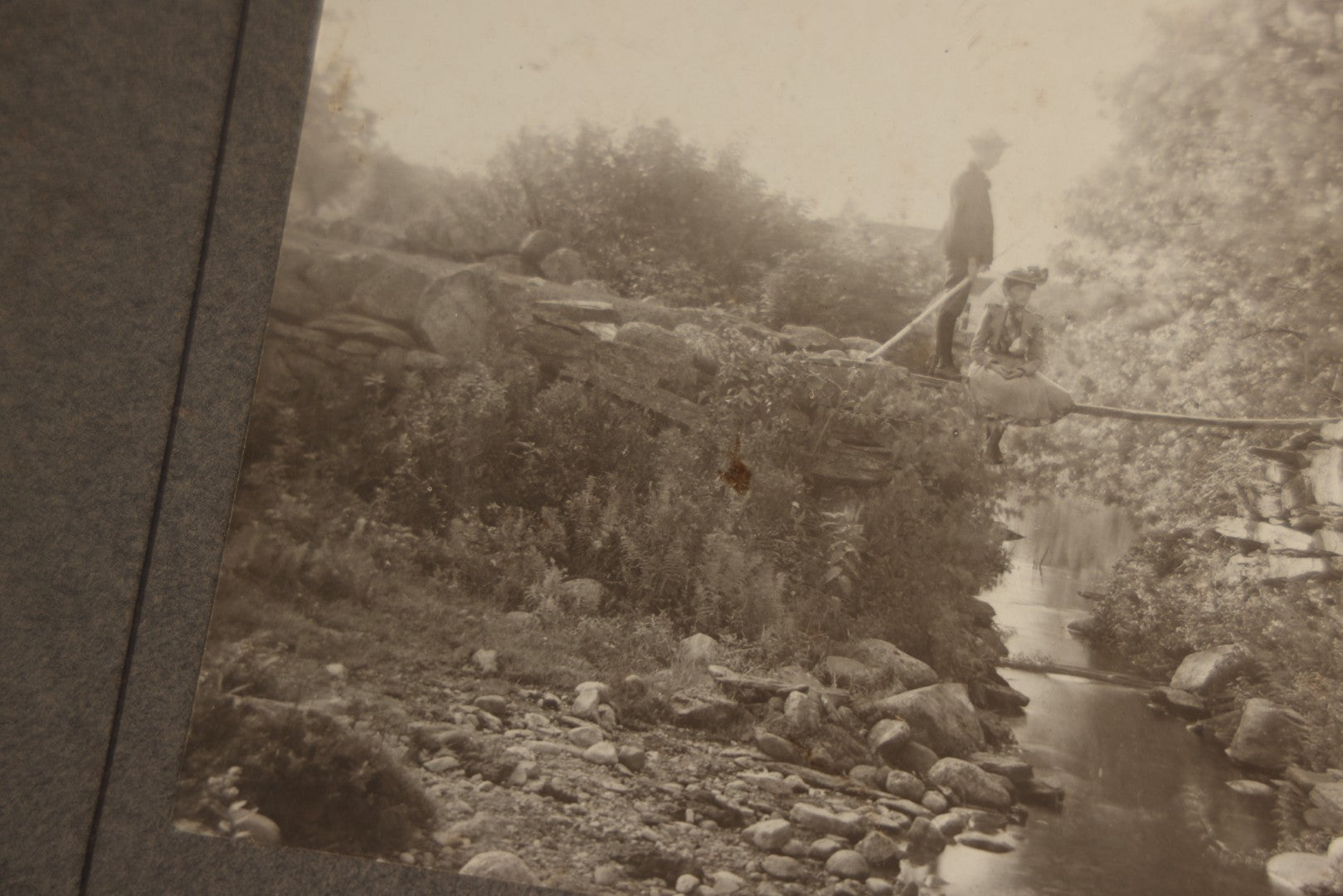 Lot 131 - Pair Of Antique Boarded Photographs Of Outdoor Scenes, Including Boy And Girl On Primitive Stick Bridge Crossing Creek, Canoe