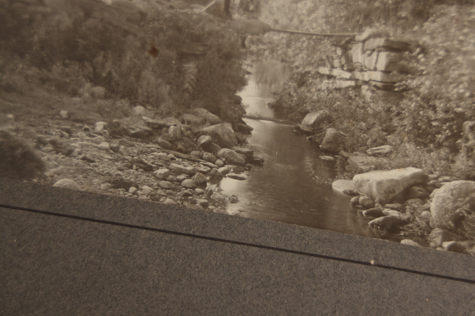 Lot 131 - Pair Of Antique Boarded Photographs Of Outdoor Scenes, Including Boy And Girl On Primitive Stick Bridge Crossing Creek, Canoe