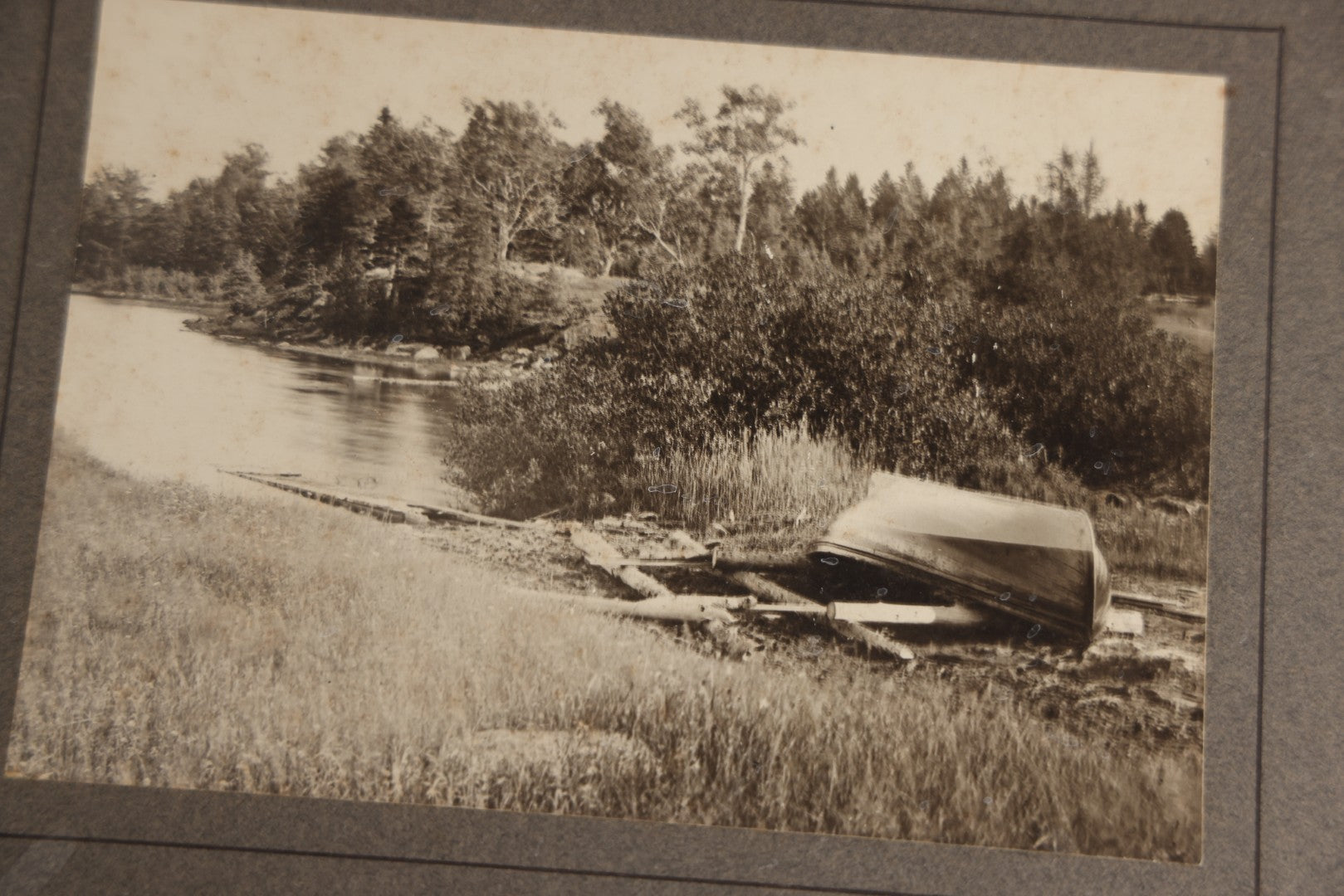 Lot 131 - Pair Of Antique Boarded Photographs Of Outdoor Scenes, Including Boy And Girl On Primitive Stick Bridge Crossing Creek, Canoe