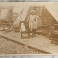 Lot 132 - Antique Unmounted Photograph Of A Little Girl With Her Doll Standing On A Tent Porch