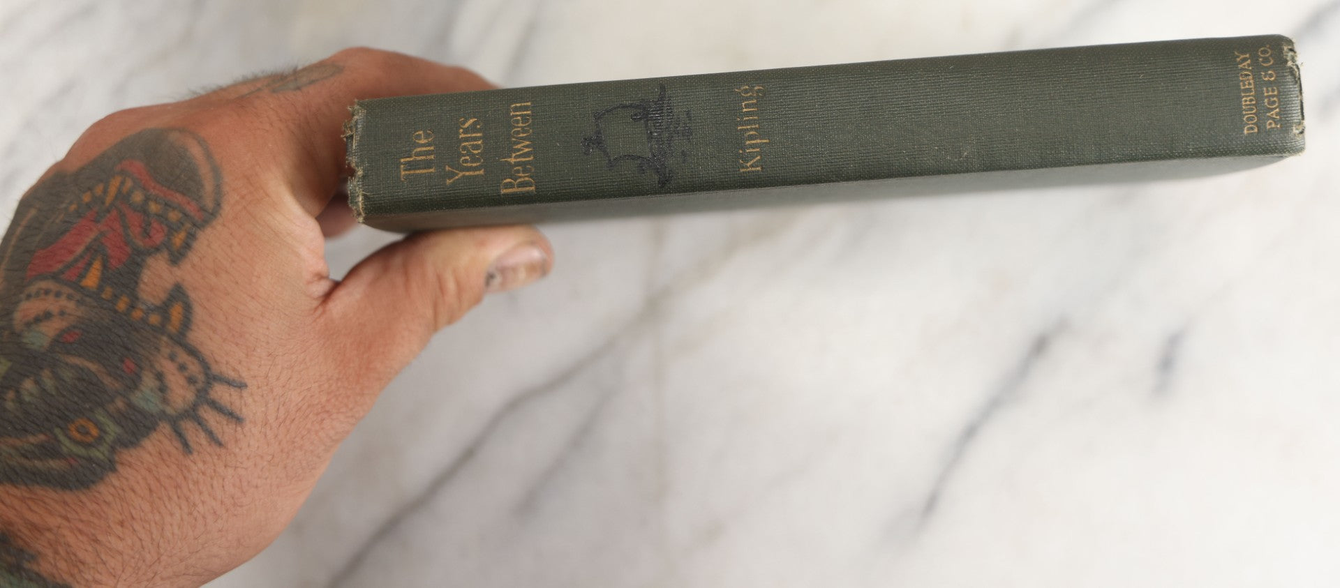 Lot 139 - "The Years Between" Antique Poetry Book By Rudyard Kipling, Green Cloth Boards With Gilt Title And Black Pictorial Sailing Ship Motif, Doubleday, Page & Company, Garden City, New York, 1919