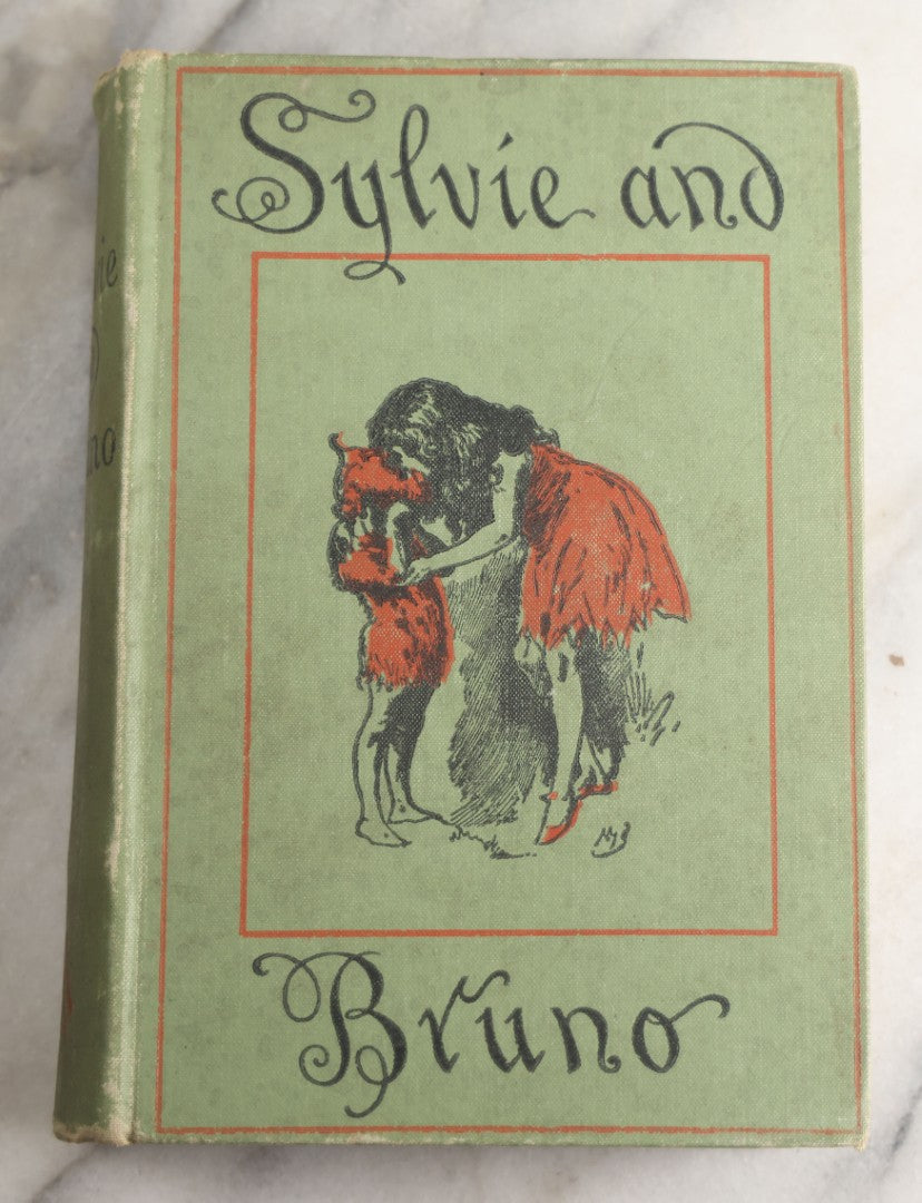Lot 188 - Pair Of Antique Books, "Sylvie And Bruno" And "Sylvie And Bruno Concluded" By Lewis Carroll, Matching Illustrated Green Cloth Covers With Red And Black Designs, Macmillan And Co., Limited, Publisher, London, 1898