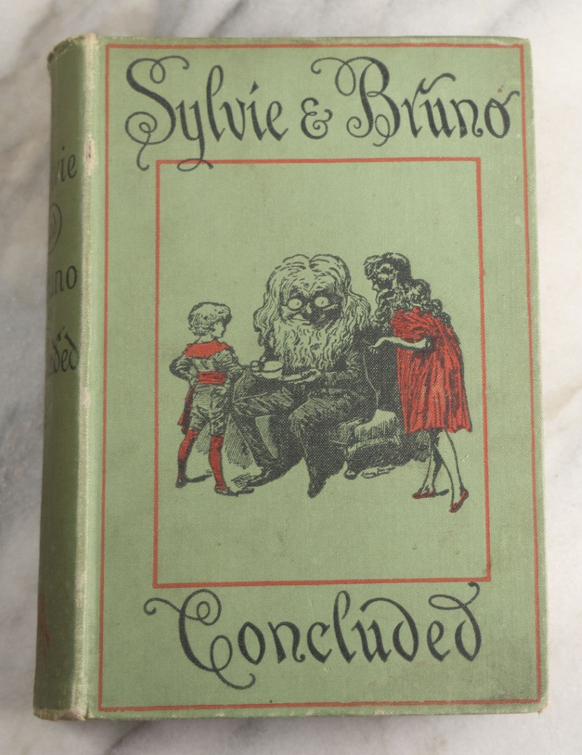 Lot 188 - Pair Of Antique Books, "Sylvie And Bruno" And "Sylvie And Bruno Concluded" By Lewis Carroll, Matching Illustrated Green Cloth Covers With Red And Black Designs, Macmillan And Co., Limited, Publisher, London, 1898