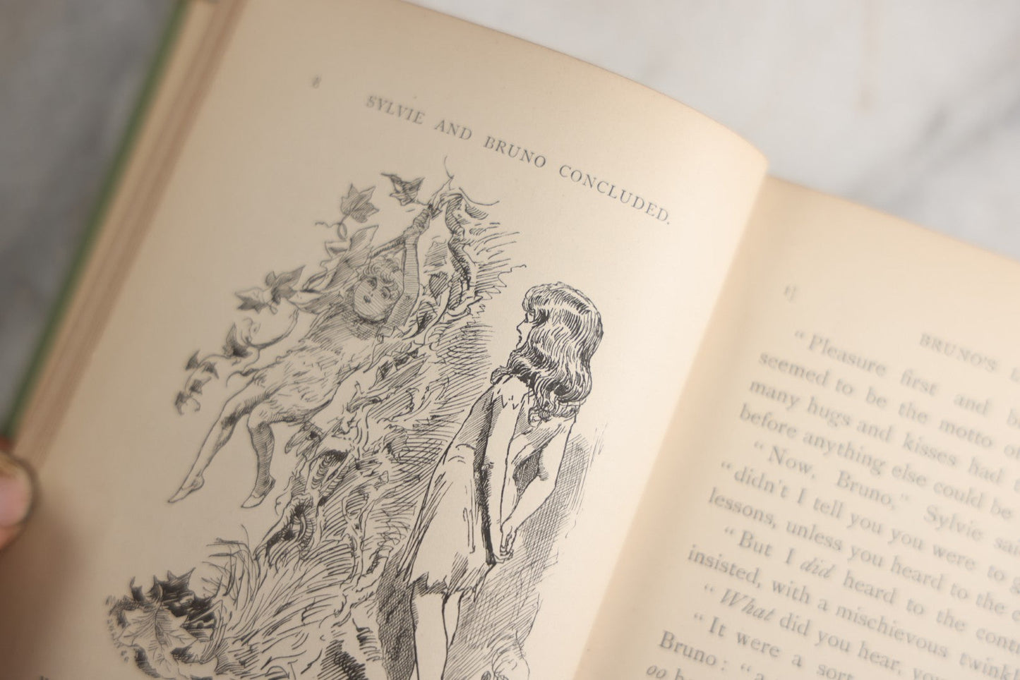 Lot 188 - Pair Of Antique Books, "Sylvie And Bruno" And "Sylvie And Bruno Concluded" By Lewis Carroll, Matching Illustrated Green Cloth Covers With Red And Black Designs, Macmillan And Co., Limited, Publisher, London, 1898