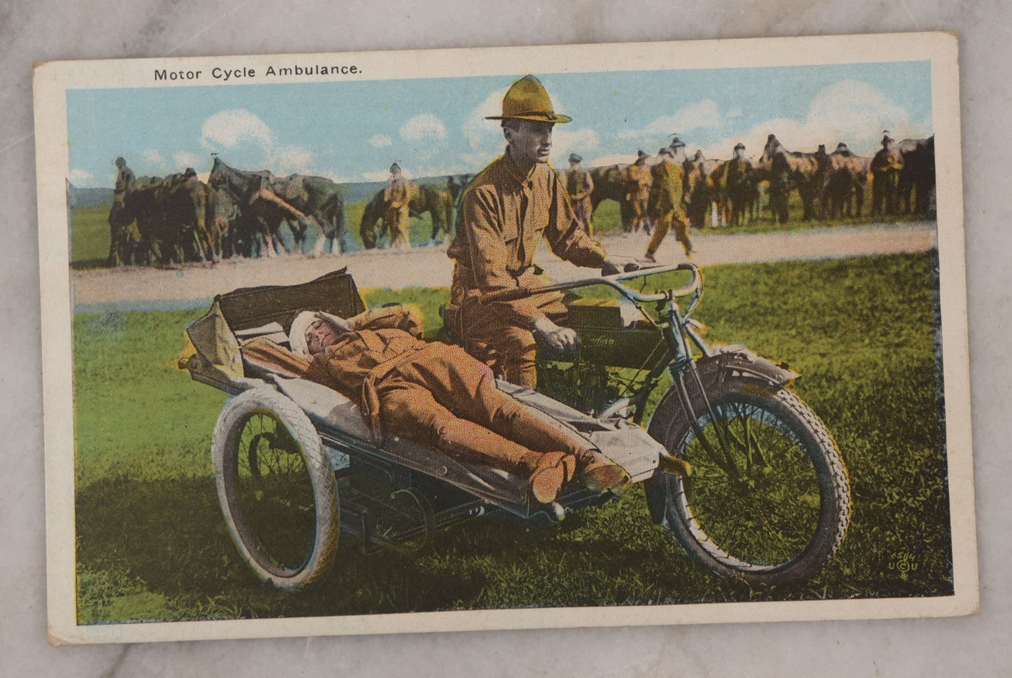 Lot 082 - Grouping Of Five Antique World War One Era Postcards Documenting The War Including Comic Illustration, Uncle Sam Placing Kaiser In Garbage, Soldier Shaving, Tank In Action, Motorcycle Ambulance, And Rifle Practice
