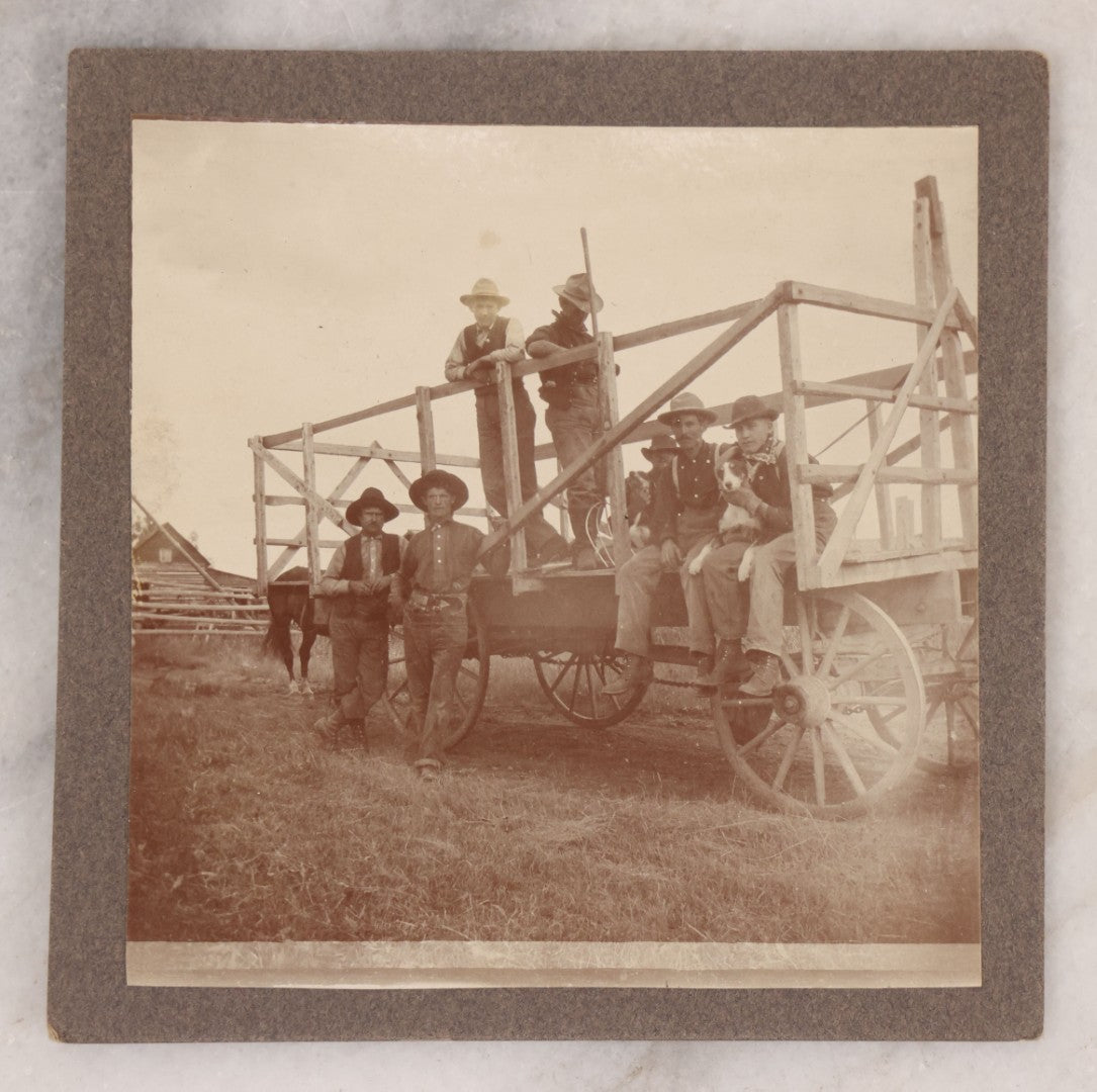 Lot 096 - Antique Boarded Occupational Photograph Of A Group Of Farm Workers Posing With Their Dog On A Wooden Cart