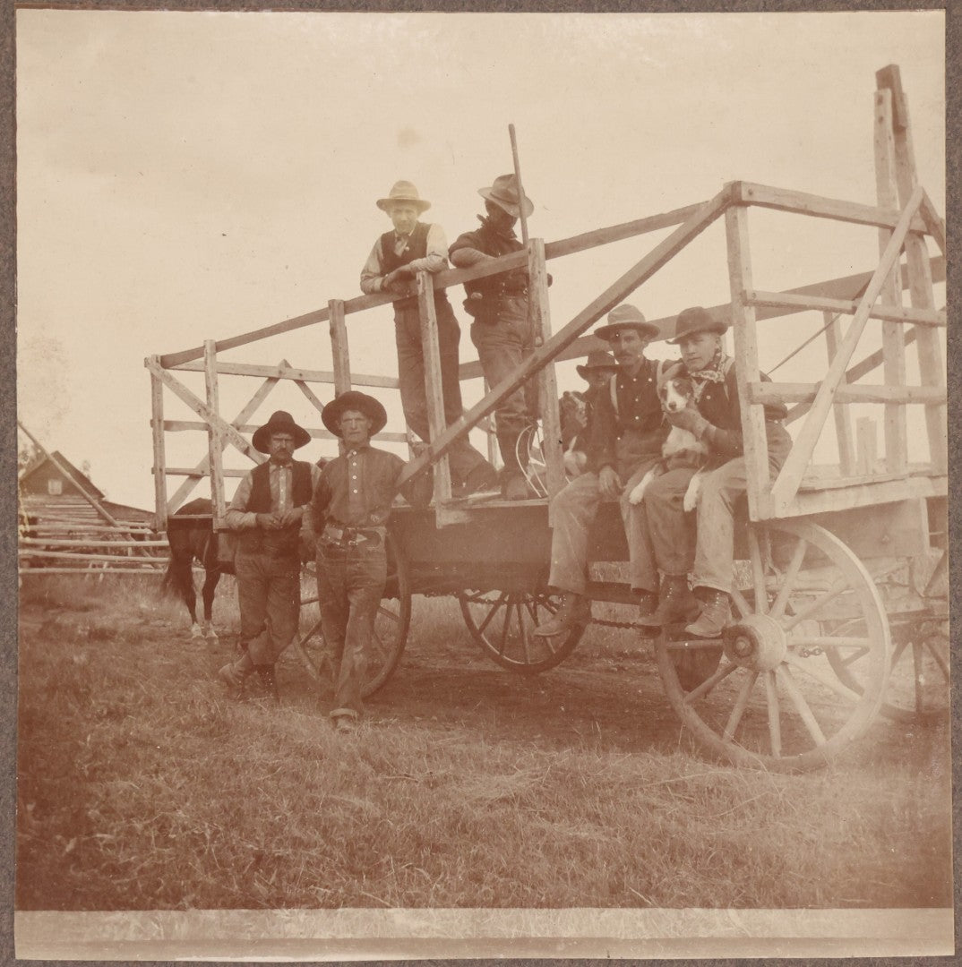 Lot 096 - Antique Boarded Occupational Photograph Of A Group Of Farm Workers Posing With Their Dog On A Wooden Cart