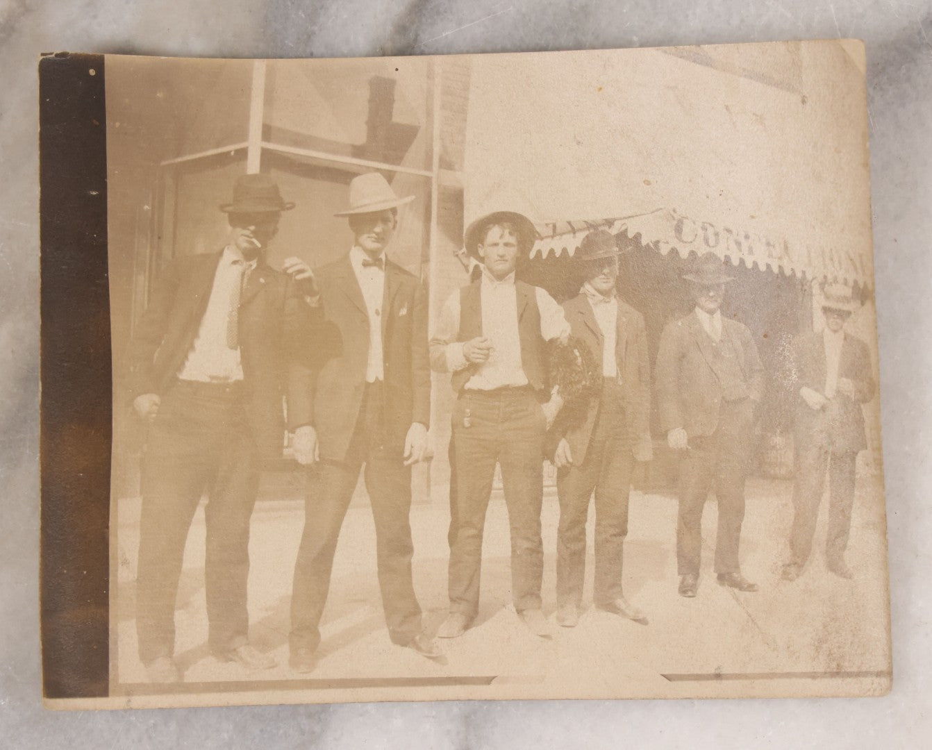 Lot 097 - Grouping Of Three Antique Unmounted Paper Photographs Of Men Posing In And Around Albany County, New York, Including With Horses, In Front Of Confectionary Shop, And Holding Paper With Headline "Choicelest Lands, Albany County"