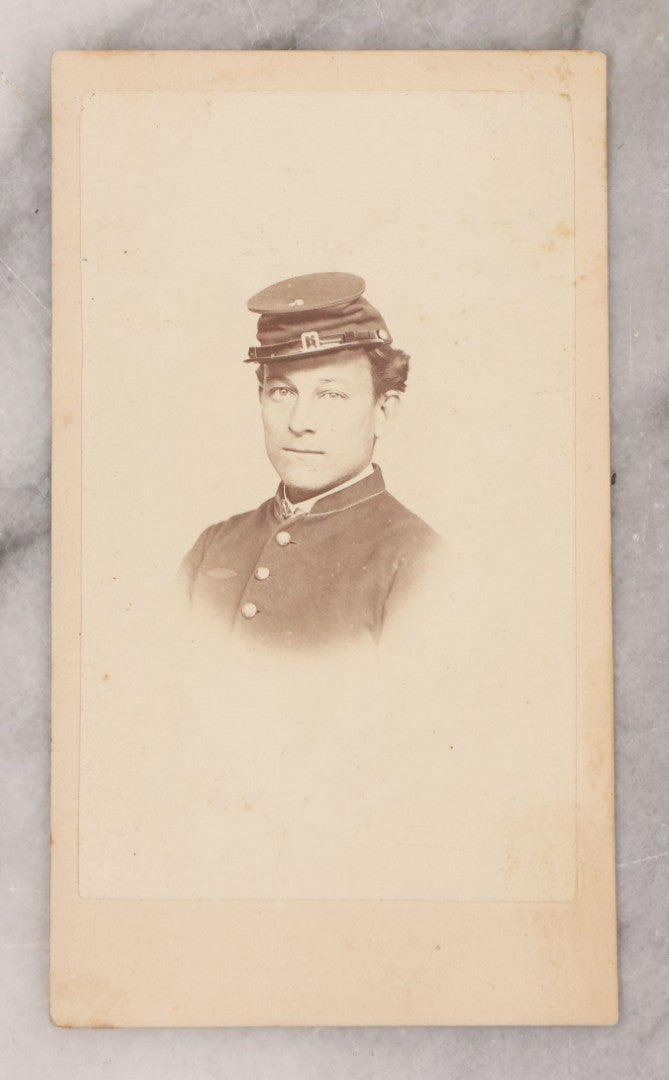 Lot 109 - Grouping Of Six Carte De Visite C.D.V. Portrait Photographs Of Men And Women, Including Man In Suit With Bowtie, Woman In Full Length Dress With Large Skirt, And Man In Officers Uniform With Slouchy Cap