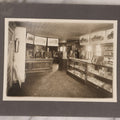 Lot 157 - Vintage Boarded Photograph Of An Early Ford Automobile Car Dealership, With Advertisement For Ford V8 Engine, Select Vehicles, Many Products For Sale, Circa 1930s