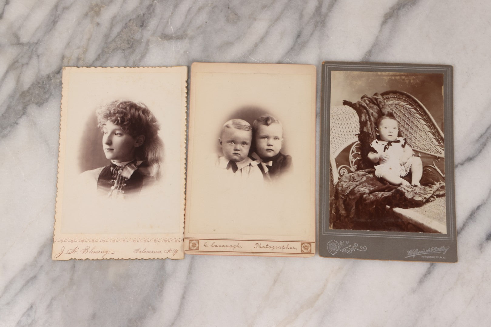 Lot 158 - Grouping Of Fifteen Antique Cabinet Card Photographs Of Men, Women, And Children, Including Woman Holding Hat With Umbrella, Parents With Child, Girl With Locket, And More