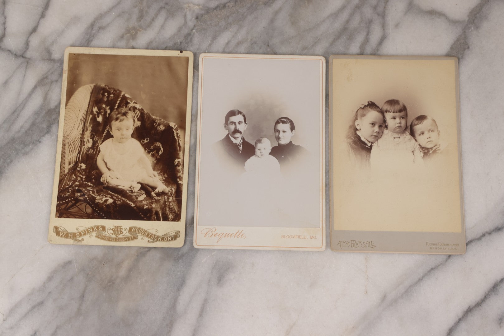 Lot 158 - Grouping Of Fifteen Antique Cabinet Card Photographs Of Men, Women, And Children, Including Woman Holding Hat With Umbrella, Parents With Child, Girl With Locket, And More