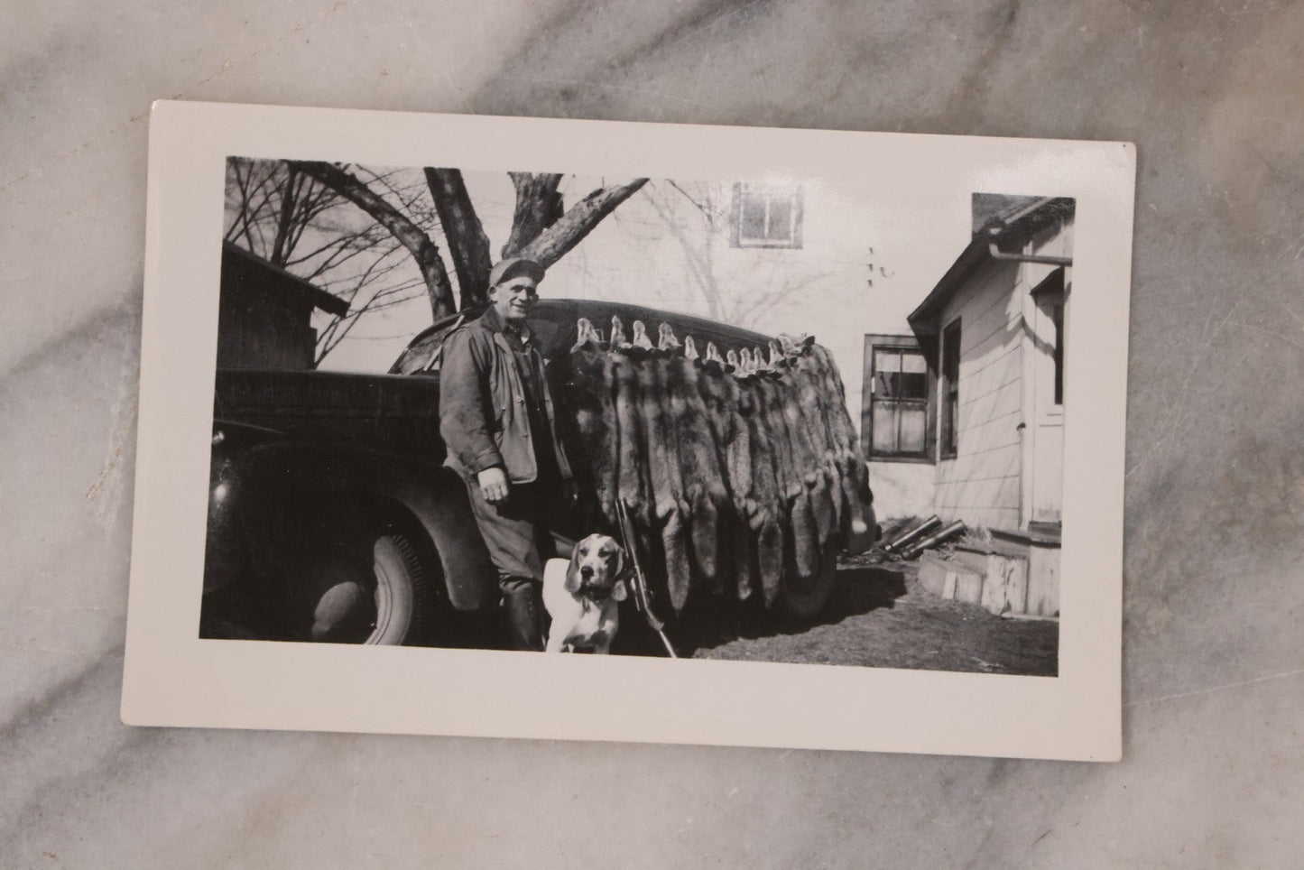 Lot 165 - Grouping Of Nine Vintage Snapshot Photographs Of Outdoorsmen, Hunters, Trappers, Fisherman, And Their Catches, Including Many Photos Of Furs, Hunting Dogs, Etc.