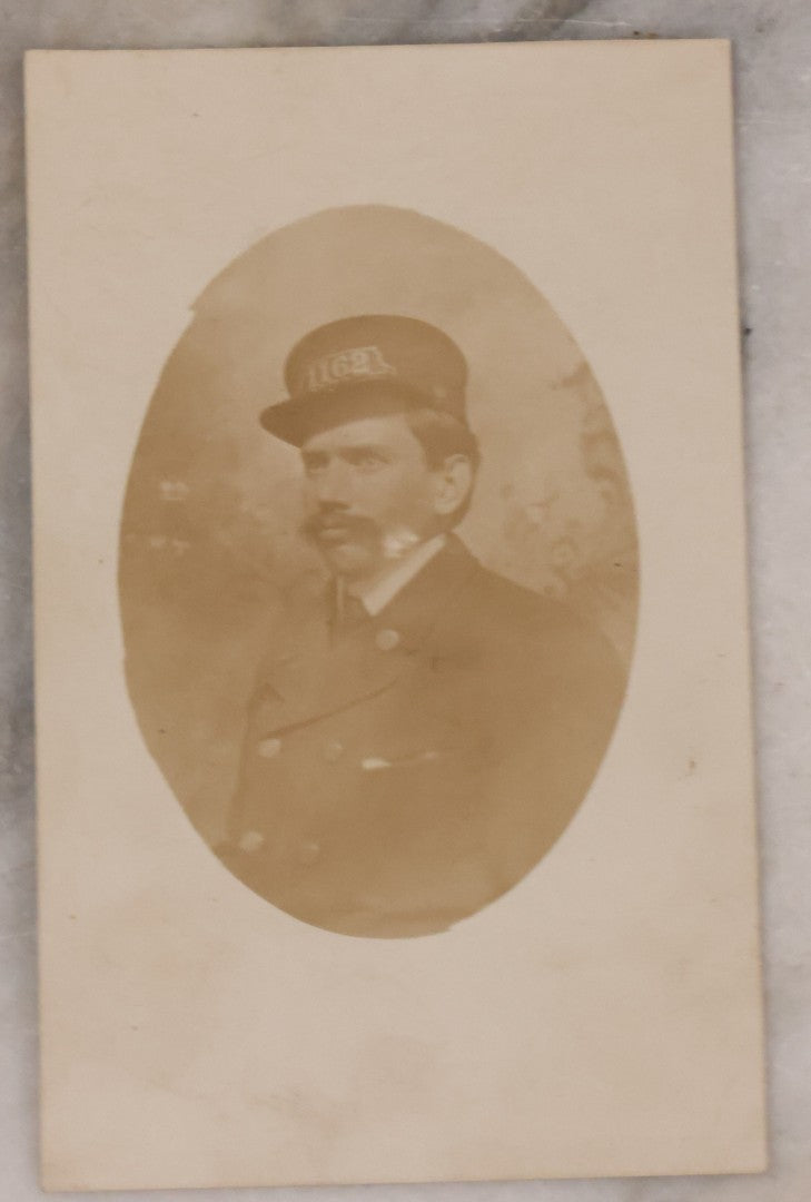 Lot 166 - Grouping Of Four Antique Occupational Photographs Including Miniature Boarded Photo Of Possible Firefighter, R.P.P.C. Of Men With Horse And Carriage, R.P.P.C. Of Train Conductor, And Poor Condition R.P.P.C. Of Sawmill