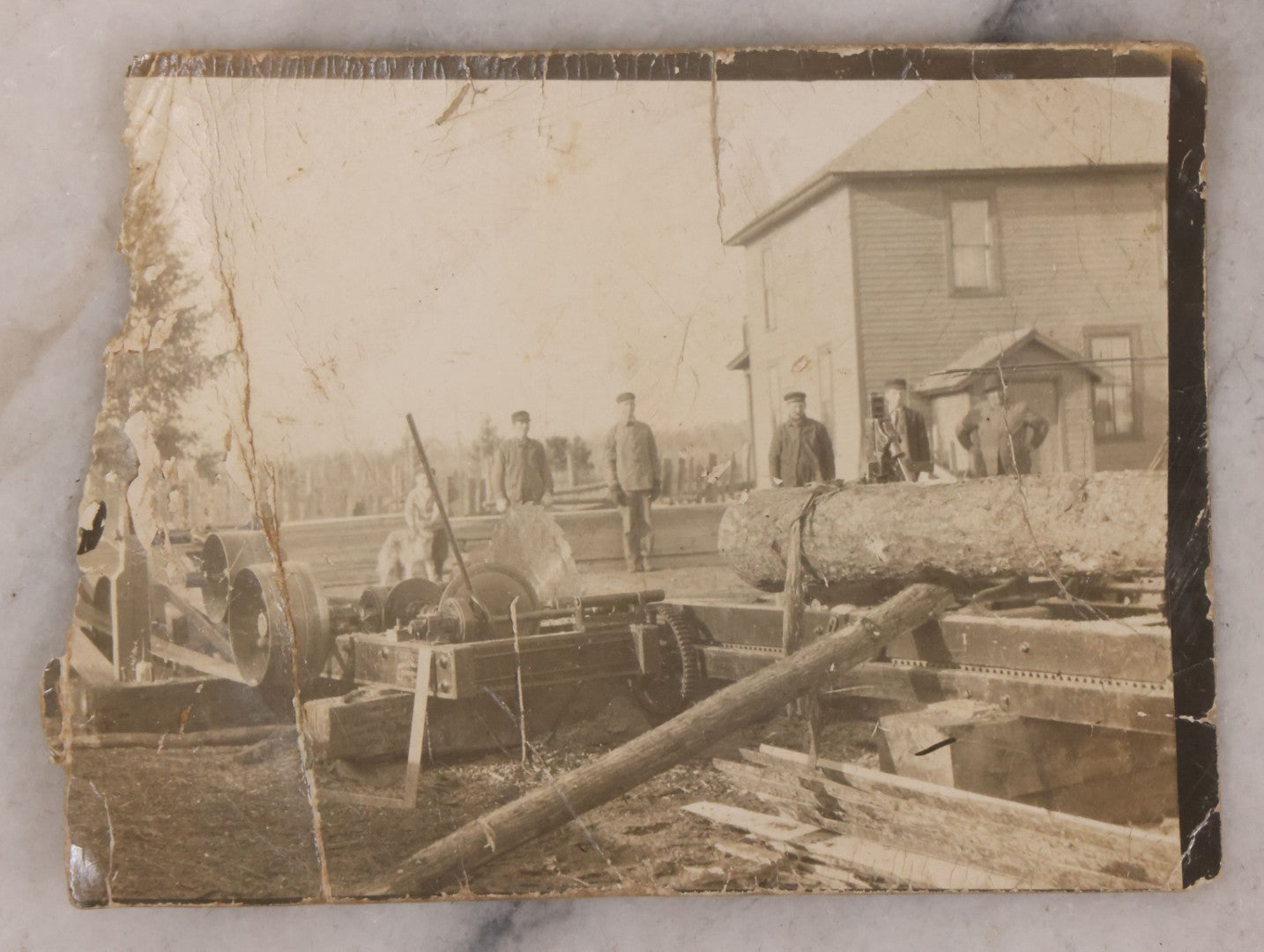Lot 166 - Grouping Of Four Antique Occupational Photographs Including Miniature Boarded Photo Of Possible Firefighter, R.P.P.C. Of Men With Horse And Carriage, R.P.P.C. Of Train Conductor, And Poor Condition R.P.P.C. Of Sawmill