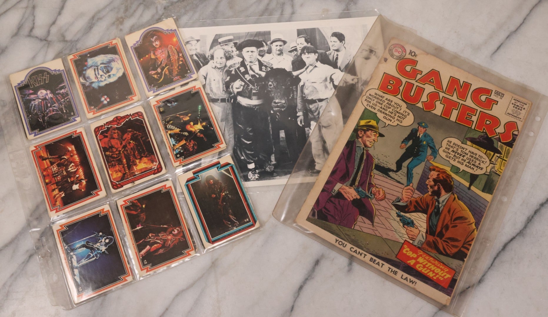 Lot 169 - Vintage Ephemera Grouping Including 18 Collectible Kiss Trading Cards, D.C. Gang Busters Comic No. 58, And Three Stooges Promo Photo