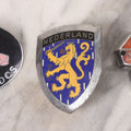 Lot 034 - Grouping Of Three Vintage Automobile Badges Including Nederland Lion Crest, Triumph Sports Owners Association, And M.A.S.C.D.C.S. Car Club