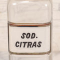 Lot 061 - Antique Whitall Tatum Co. Clear Glass Apothecary Bottle With Stopper And Reverse Painted Label “Sod. Citras”, 7-3/4" H