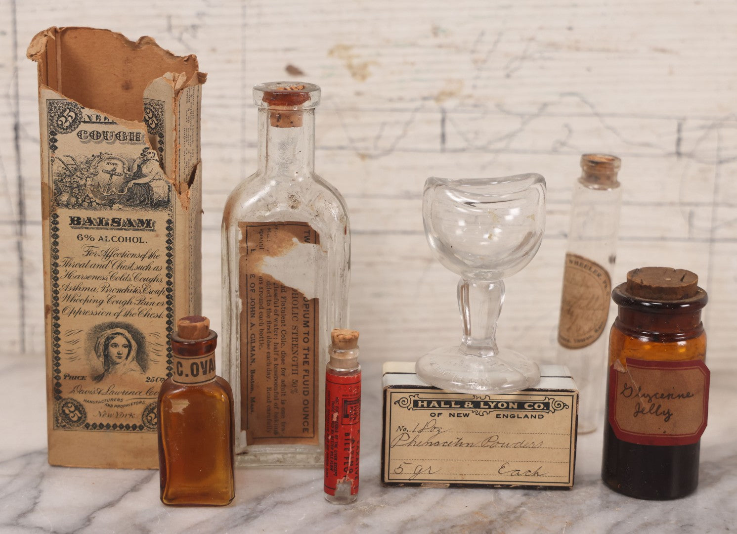 Lot 078 - Grouping Of Eight Antique Apothecary Items Including Amber Bottle With "G.C. Oval" Label, Balsam Bottle, Hall & Lyon Co. Pill Box, Carter's Laxative Vial, Wheeler Pharmacist Vial, Sharon, M.A., Glycerine Jelly Bottle, & John Bull Eye Wash Cup