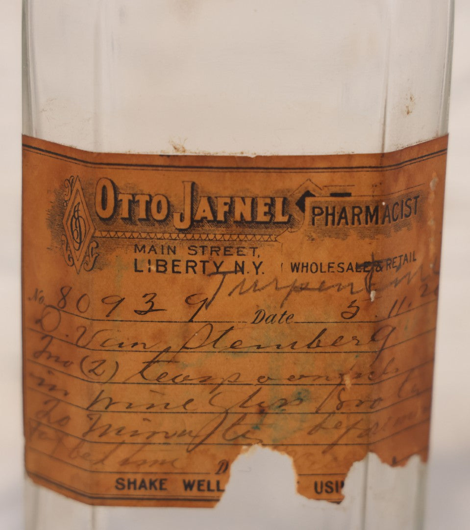 Lot 081 - Grouping Of Three Antique Clear Glass Apothecary Bottles Including Codeinae Sulfas F&S St. Louis, Bottle With Illegible Paper Label, And Otto Jafnel Pharmacist Liberty Ny