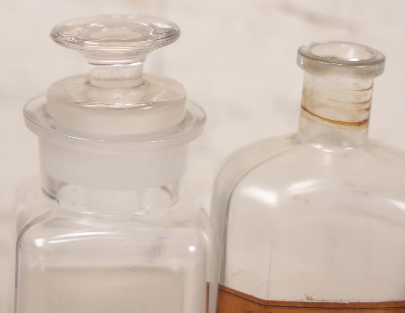 Lot 081 - Grouping Of Three Antique Clear Glass Apothecary Bottles Including Codeinae Sulfas F&S St. Louis, Bottle With Illegible Paper Label, And Otto Jafnel Pharmacist Liberty Ny