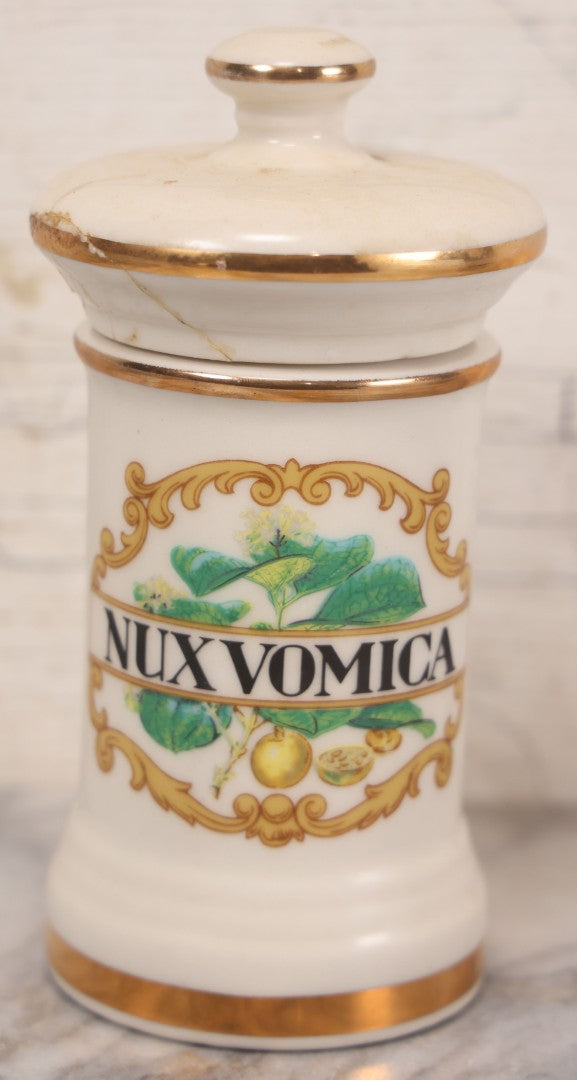 Lot 084 - Reproduction Fantasy Apothecary Jar With Lid Marked “Nux Vomica” White Opaque Pottery With Gold Painted Lines, Mid-20th Century, Bottom Marked Made In U.S.A., Note Broken And Repaired Lid, 7-5/8" H