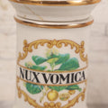 Lot 084 - Reproduction Fantasy Apothecary Jar With Lid Marked “Nux Vomica” White Opaque Pottery With Gold Painted Lines, Mid-20th Century, Bottom Marked Made In U.S.A., Note Broken And Repaired Lid, 7-5/8" H
