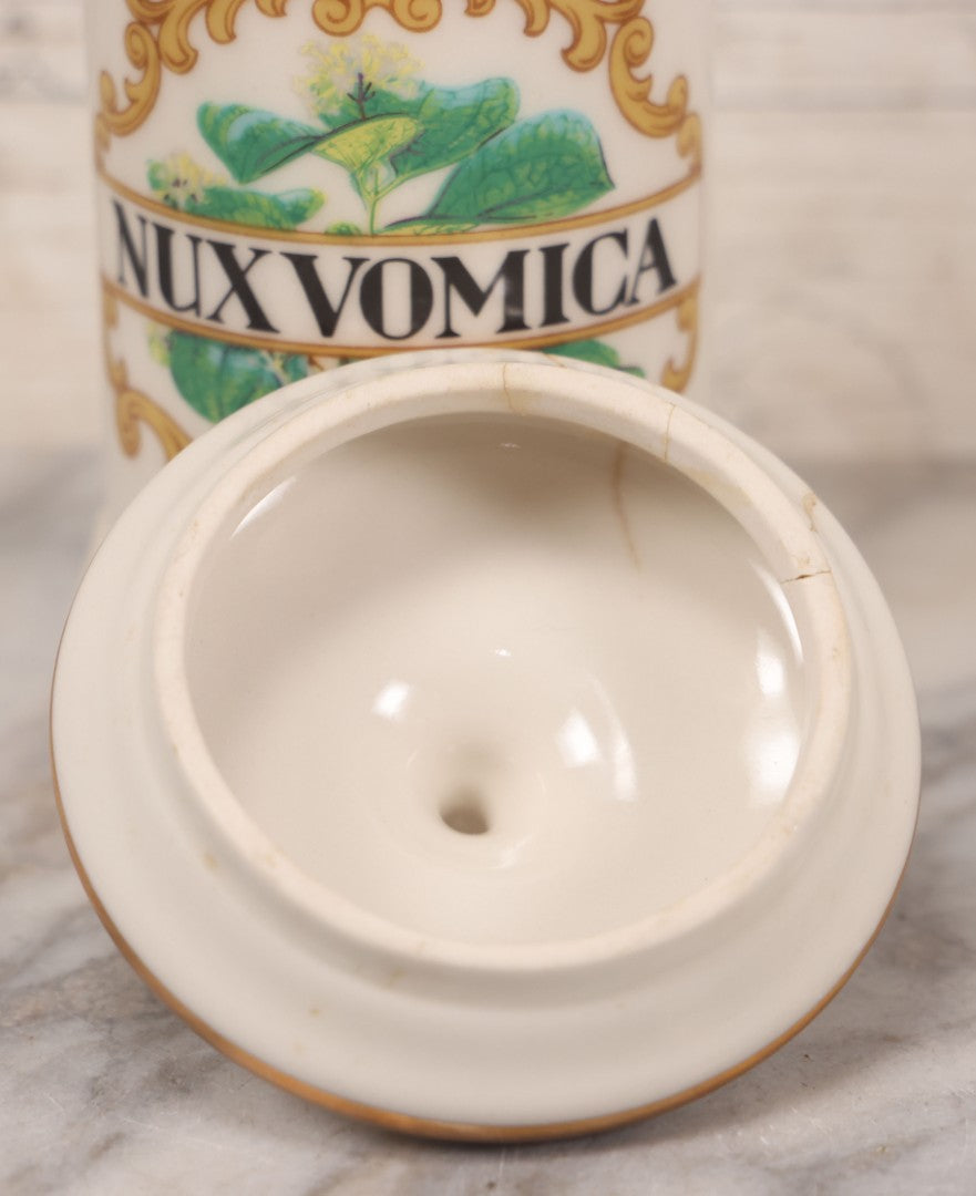 Lot 084 - Reproduction Fantasy Apothecary Jar With Lid Marked “Nux Vomica” White Opaque Pottery With Gold Painted Lines, Mid-20th Century, Bottom Marked Made In U.S.A., Note Broken And Repaired Lid, 7-5/8" H