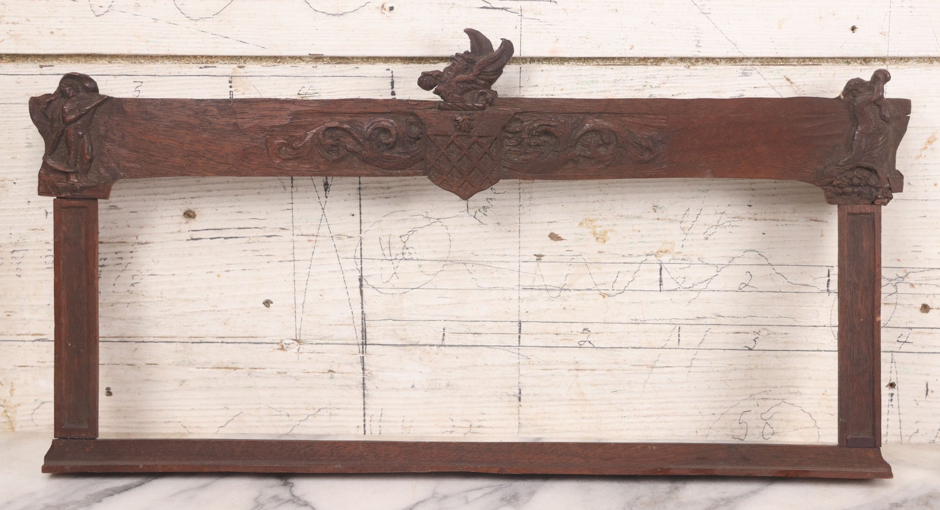 Lot 086 - Antique Hand Carved Wood Folk Art Frame With Griffin Motif, Coat Of Arms, Cherub Corners, Original Finish, 18-1/2" x 9-1/4"