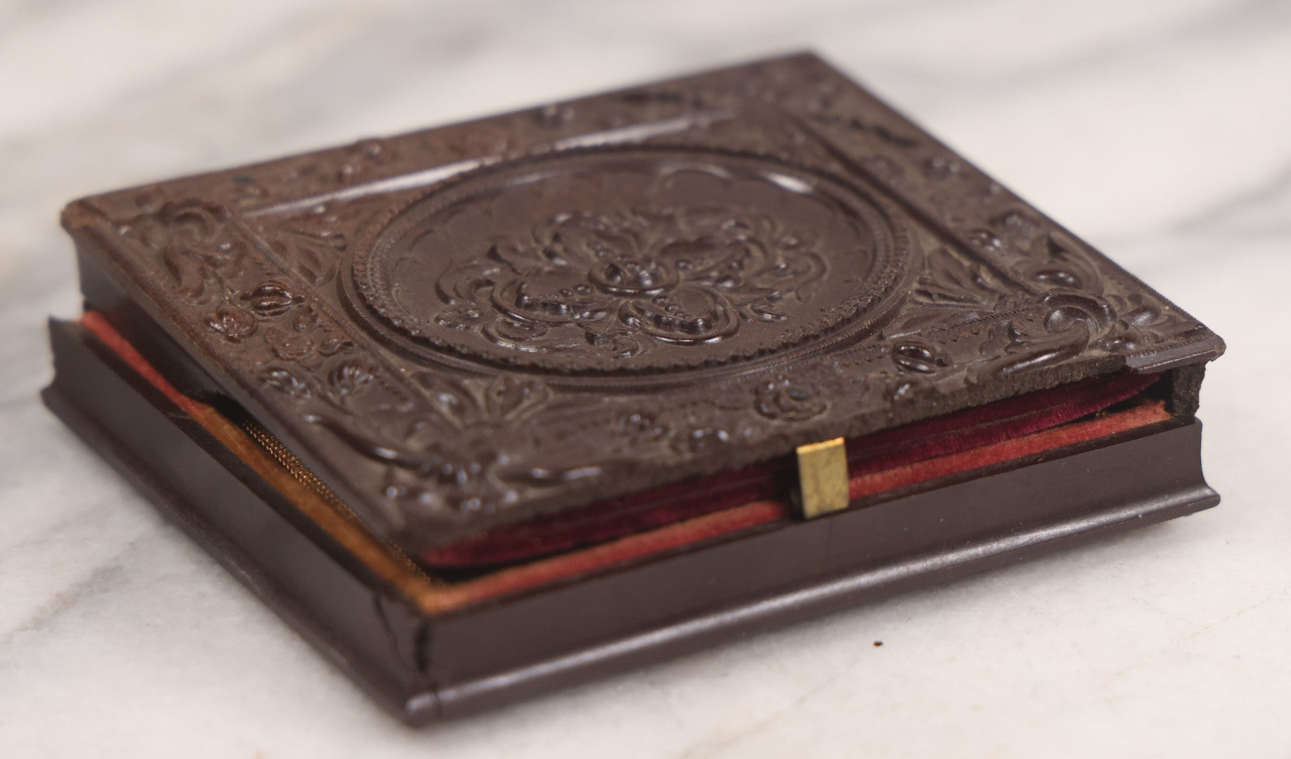 Lot 094 - Antique 1/6th Plate Daguerreotype Photograph Of Man In Full Thermoplastic Case With Abstract Floral Design, Brass Mat, Dark Red Cushion, Heavily Speckled Surface Of Photograph, Note Damage To Case