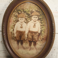 Lot 017 - Antique Sepia Toned Color Tinted Photograph Of Two Brothers In Matching Outfits In Bubble Glass Frame, 14-7/8" x 19-7/8"