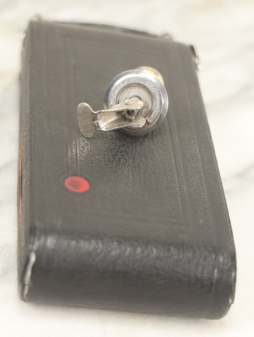 Lot 085 - Vintage Drinking Flask Disguised As Antique Folding Camera With Internal Pyrex Glass Flask, Note Missing Screw And Worn Stopper