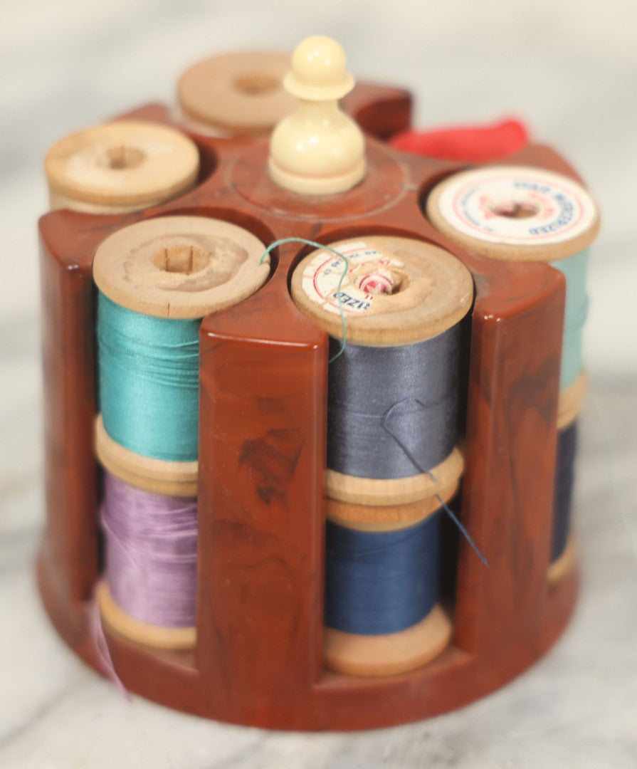 Lot 107 - Antique And Vintage Sewing Lot Including Marbled Plastic Thread Holder With Pin Cushion, Metal Mushroom Thread Holder, Two Thimbles, And Cast Iron Table Clamp Thread Holder By Herter's, Waseca Minn., No. 29