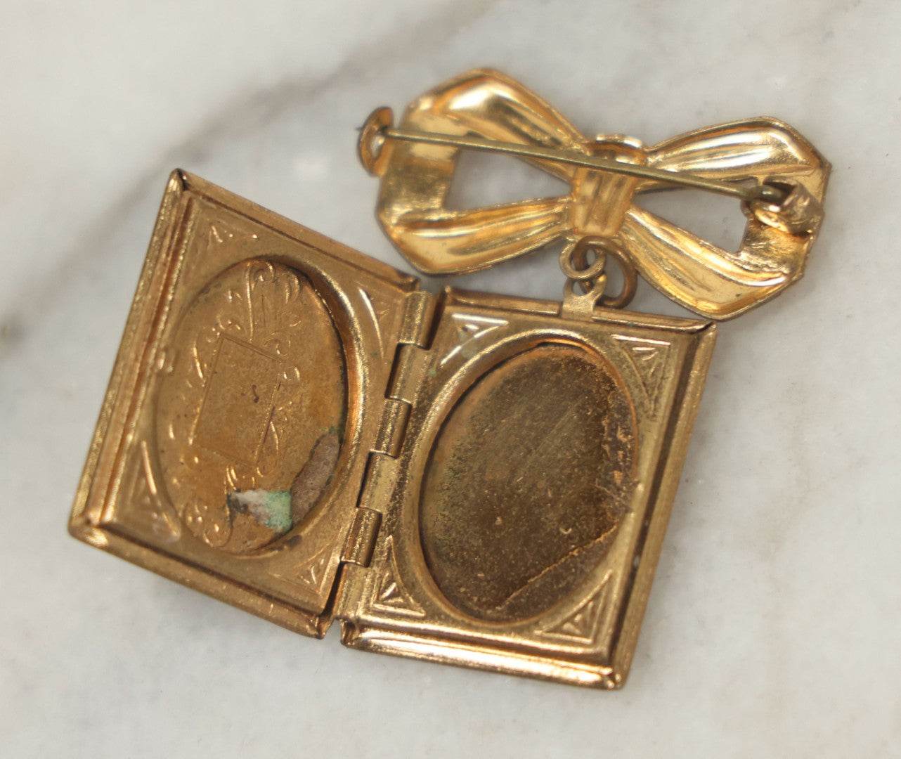 Lot 123 - Vintage Gold-Tone Bow Brooch With Dangling Book-Form Locket Monogrammed “M & B”
