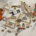 Lot 125 - Grouping Of 10+ Vintage Junk Drawer Items Including Jewelry, Pins, Tie Bars, And Wooden Bunny Chicago 1943 Pin
