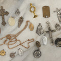 Lot 126 - Grouping Of 10+ Vintage Religious Items Including Crucifixes, Charms, “Our Father” Dog Tag, Pinback Button, And More