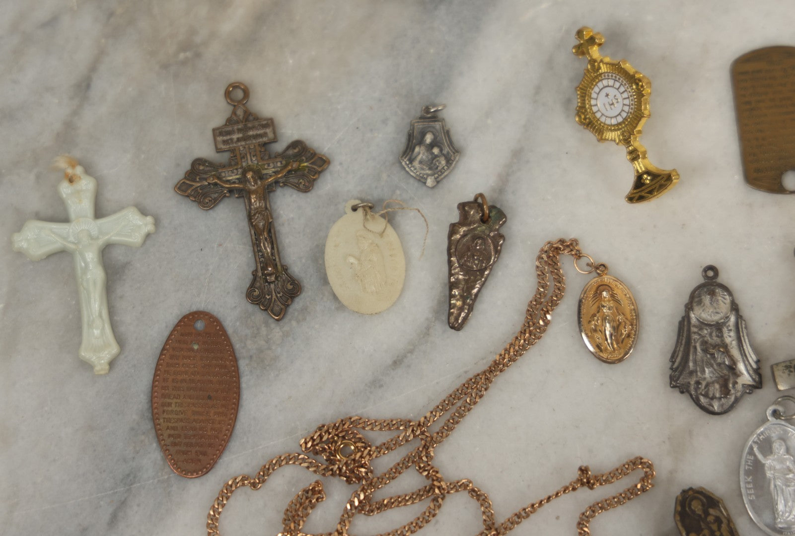 Lot 126 - Grouping Of 10+ Vintage Religious Items Including Crucifixes, Charms, “Our Father” Dog Tag, Pinback Button, And More