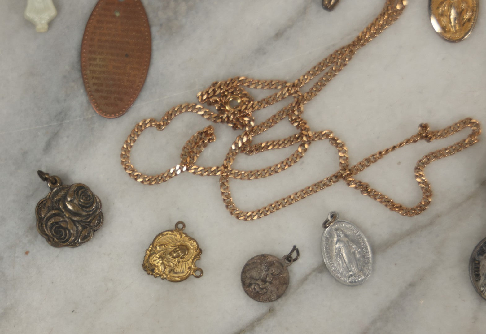 Lot 126 - Grouping Of 10+ Vintage Religious Items Including Crucifixes, Charms, “Our Father” Dog Tag, Pinback Button, And More