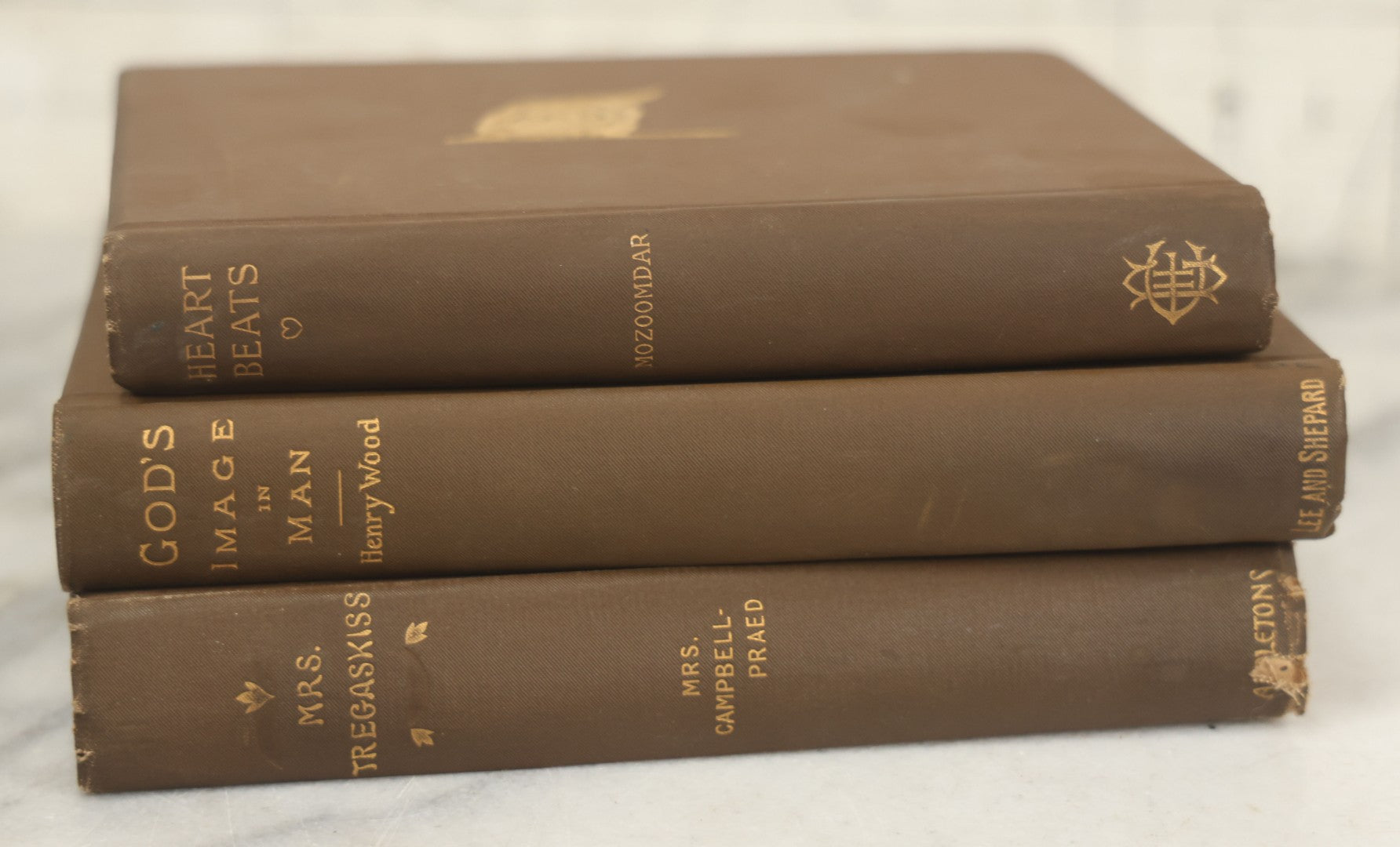 Lot 171 - Grouping Of Three Antique Books With Matching Brown Book Cloth Binding, Including "Heart-Beats" By P.C. Mozoomdar (1894), "God's Image In Man" By Henry Wood (1893), And "Mrs. Tregaskiss" By Mrs. Campbell-Praed (1895)
