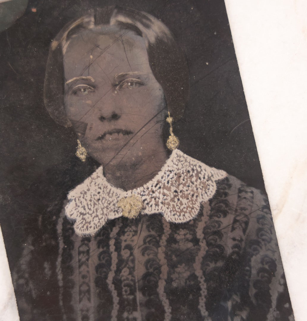 Lot 103 - Antique Tintype Photograph Of Woman With A Toothy, Stoic Expression, Hand-Painted Details, Slightly Smaller Than Half Plate
