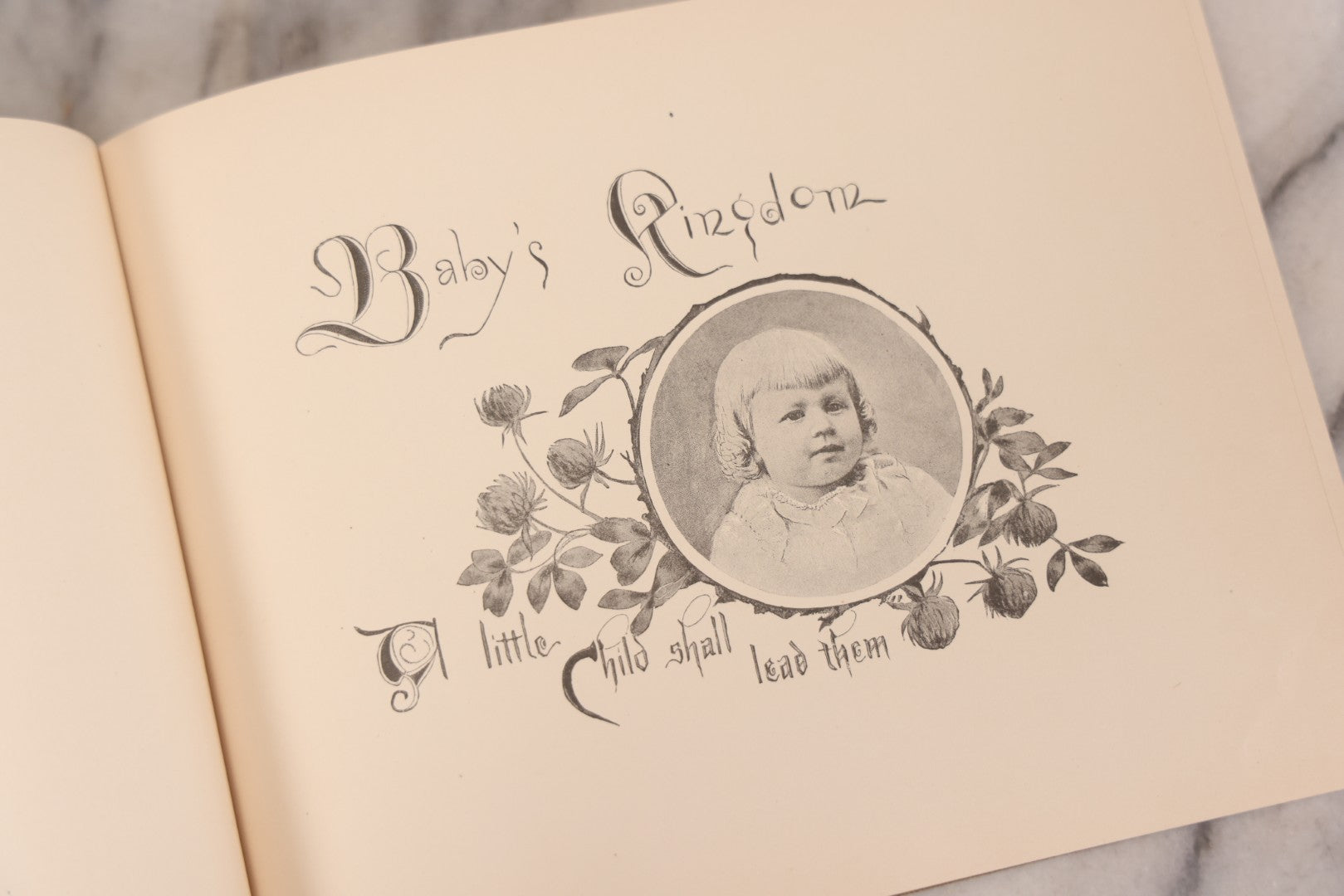 Lot 131 - "Baby's Kingdom" Antique Illustrated Baby Book With Gilt Embossed Clovers And Lettering On Cover, Gilt Foredge, Some Records Of Baby Harold Schenck, Born July 1892, With Calligraphy And Memos From Parents On 10+ Pages