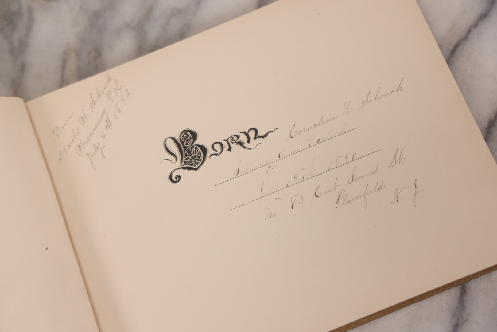 Lot 131 - "Baby's Kingdom" Antique Illustrated Baby Book With Gilt Embossed Clovers And Lettering On Cover, Gilt Foredge, Some Records Of Baby Harold Schenck, Born July 1892, With Calligraphy And Memos From Parents On 10+ Pages