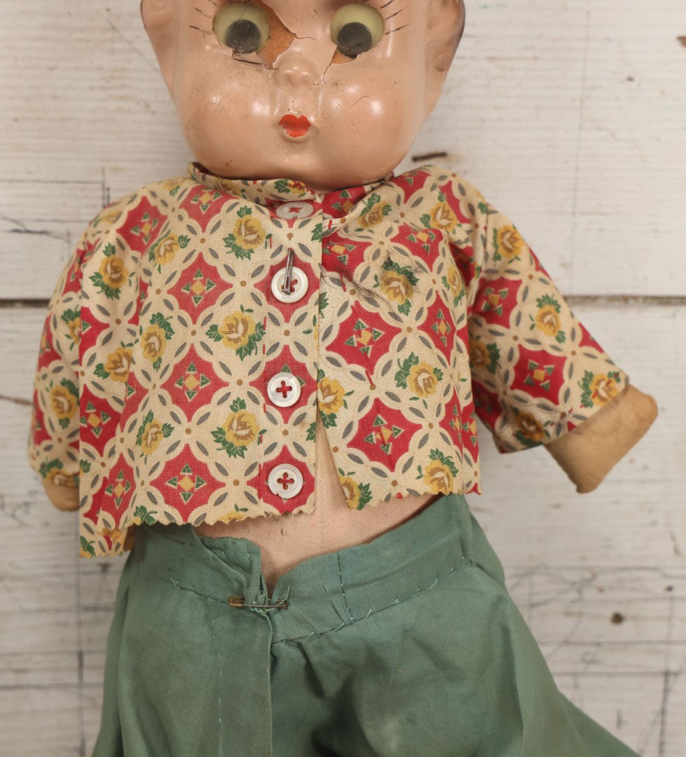Lot 086 - Vintage Composition Head Googly Eye Baby Doll With Wooden Feet And Cloth Body, Wearing Patterned Shirt And Green Pants, 15-1/2" H