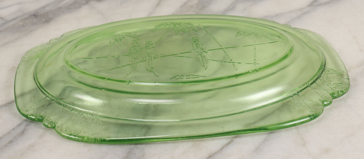 Lot 089 - Vintage Green Uranium Vaseline Glass Oval Dish By Federal Glass, Tropical Parrot And Palm Tree Motifs, Raised Underside Designs, Circa 1931, 11-1/2" x 8-1/4"