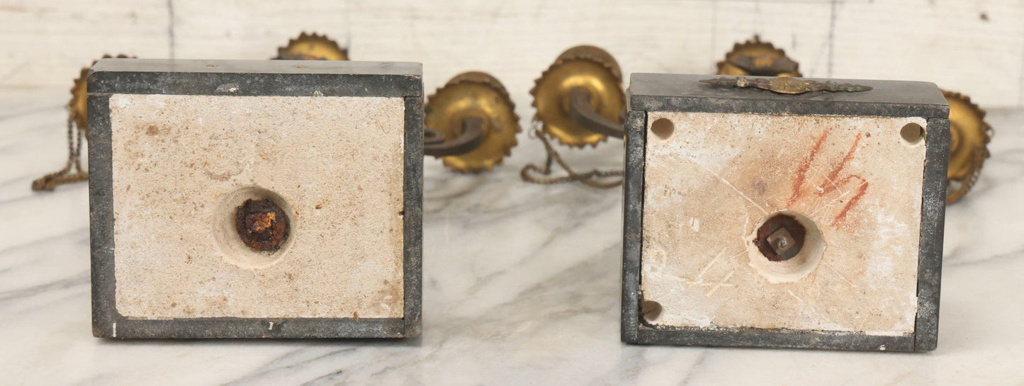 Lot 018 - Pair Of Antique Brass Three-Arm Candelabras With Floral Rosettes, Chains, And Ornate Ornamentation On Black Slate Bases, Circa 1850, 13-1/2" H Each